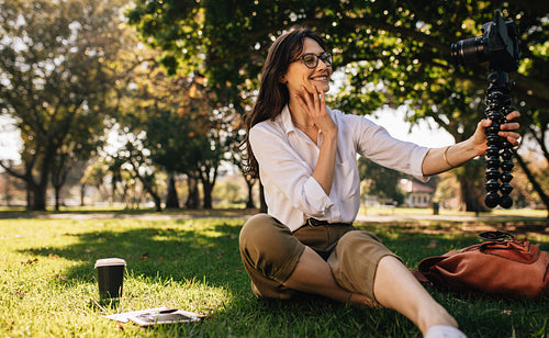 Female Vlogger recording content for her vlog at park.
