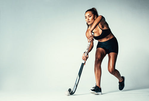 Female hockey player dribbling ball