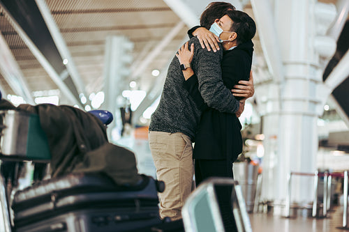 Wife receiving and welcoming her husband at airport