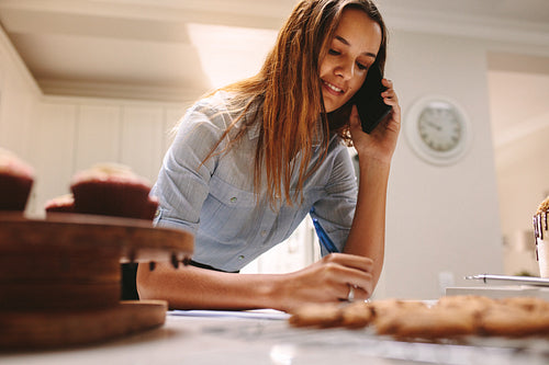 Confectioner taking orders over phone