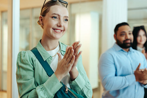 Creative agency meeting with clapping professionals