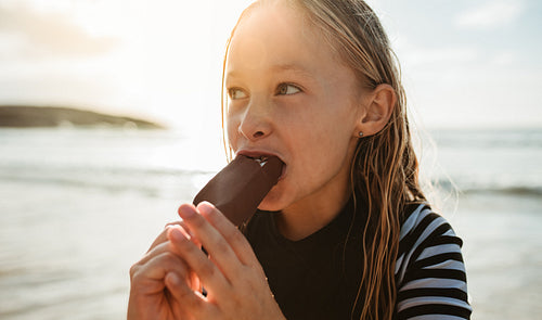 Girl eating icecream on beach