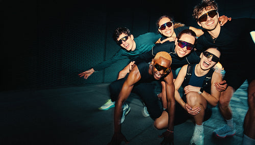 Her running group huddle brings friends together in a playful fitness portrait