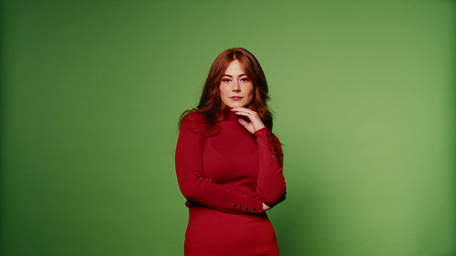 Beautiful happy redhead woman smiles and laughs on green screen background