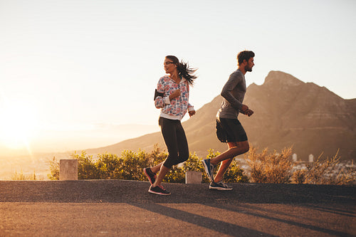 Young couple jogging on country road