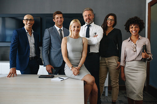 Successful and diverse business team standing together in an office
