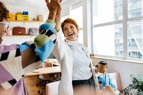 Diverse team celebrating success in a co-working space