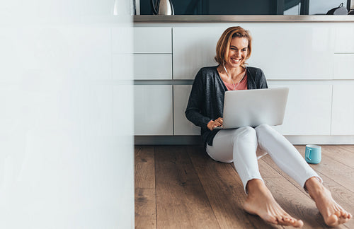 Woman video calling over laptop computer