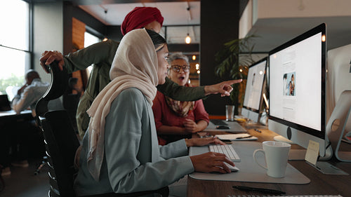 Creativity and collaboration in a coworking office as female colleagues work on a marketing campaign