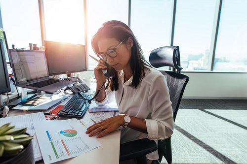 Businesswoman working at her desk in office.