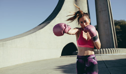 Sportswoman doing boxing working outdoors