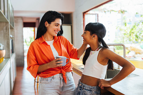 Mother and daughter enjoy quality time together in a bright modern kitchen