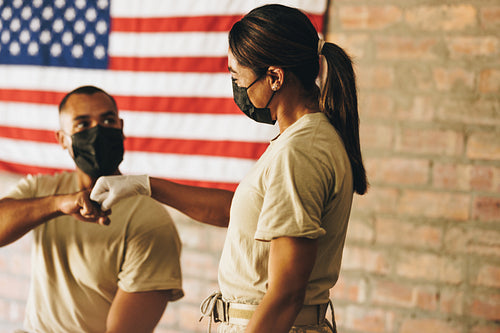 Female military nurse congratulating a soldier after vaccination