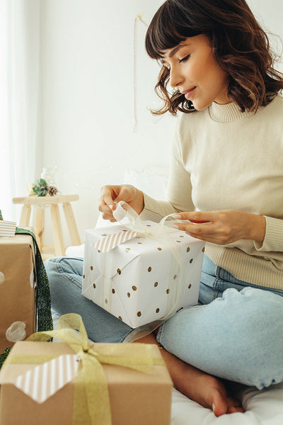 Close up of woman sitting with christmas presents