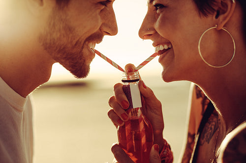 Romantic couple sharing a drink