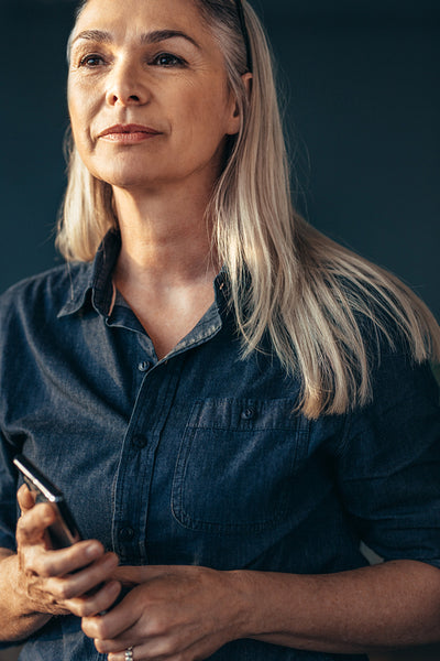 Confident mature woman in denim shirt