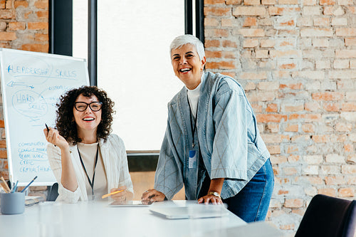 Confident female business partners collaborating in a sleek corporate atmosphere