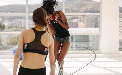 Women having fun during workout session at gym