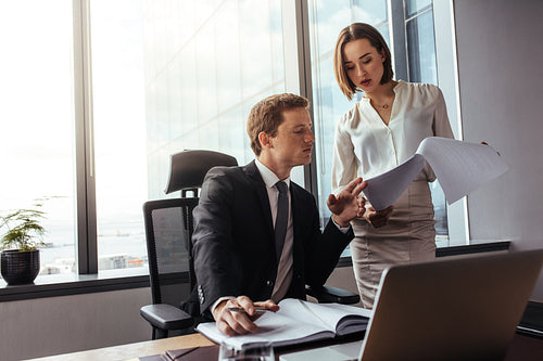 Business people reading documents in office