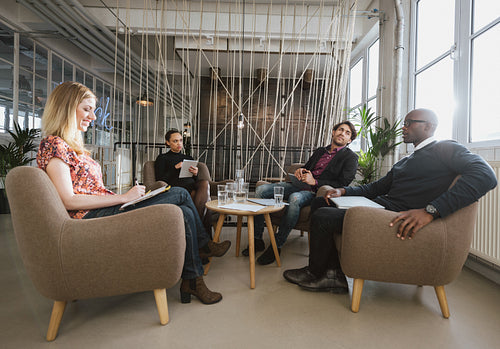 Diverse team of business people meeting in office lobby