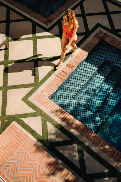 High angle view of a tourist woman going for a swim at a spa res