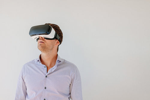 Man with VR headset looking away at the objects