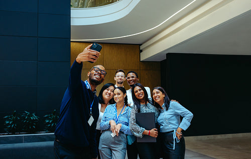 Team taking a group photo during office tour celebration