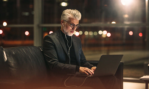 Mature businessman working on laptop in office