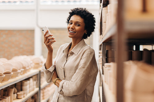 Cheerful female entrepreneur smiling at the camera in her shop