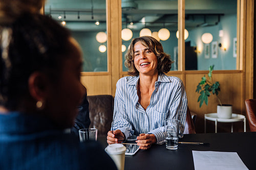 Smiling businesswoman discussing during a meeting in an office environment