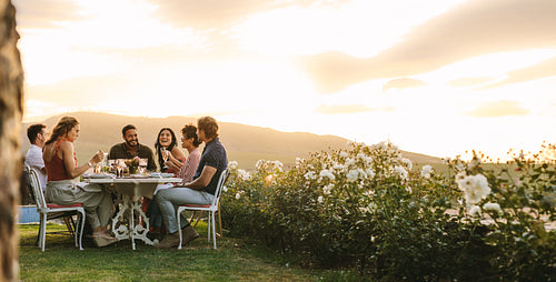 Friends hanging out at outdoors dinner party