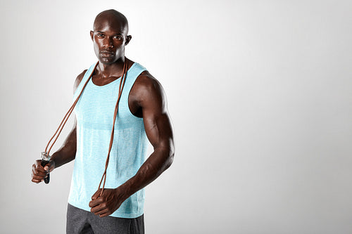Fit and muscular man with jumping rope 