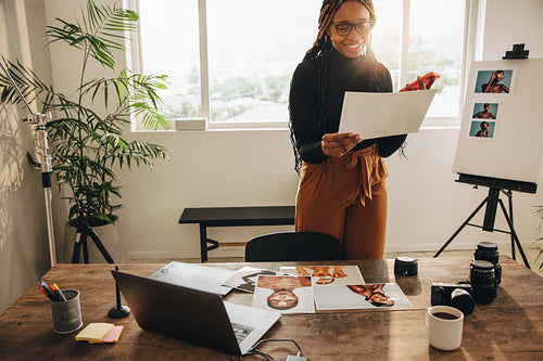 Creative photographer taking a phone call in her office
