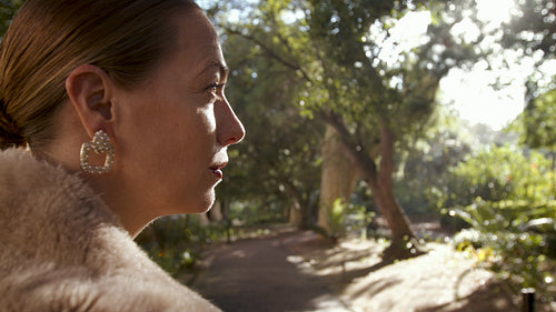 Wealthy woman in fur coat at the park