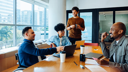 Ideas at the table: Small team collaborating in a bright office