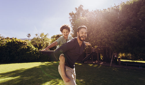 Father and son having fun playing in the park
