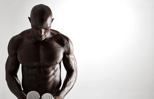 African male bodybuilder with dumbbells