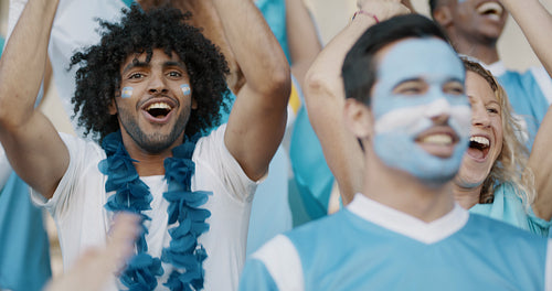 Group of cheering soccer fans from Argentina