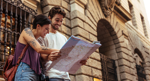 Happy tourist couple exploring the city