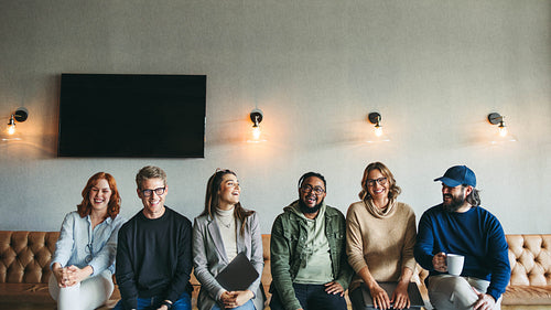 Successful business team smiling and sitting together in a startup office