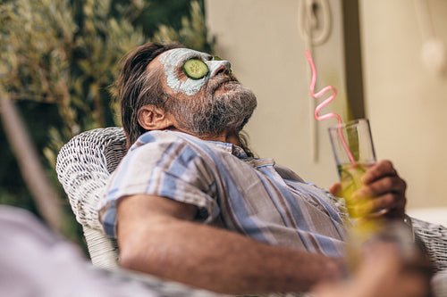 Retired man relaxing with clay mask on face
