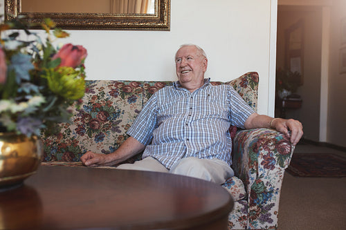 Relaxed senior man sitting on a sofa