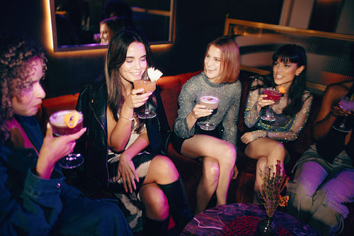Women enjoying cocktails together at a lively girls' night out