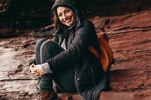 Happy woman relaxing on a mountain