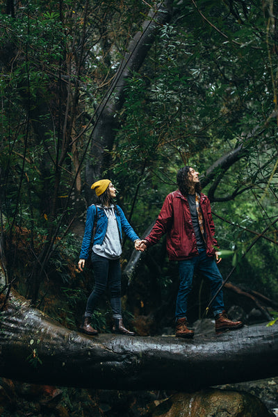 Couple hiking in forest on a rainy day