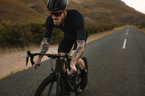 Sportsman riding a bike uphill