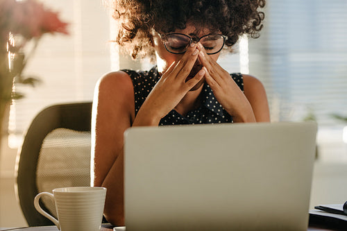 Stressed businesswoman sitting at desk