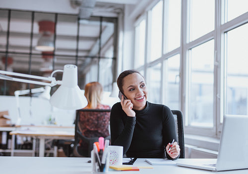 Woman using mobile phone while at work