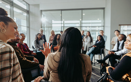 Collaborative team meeting: Coworkers engaged in discussion in a modern office