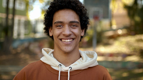Smiling teenage boy outside